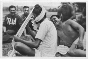 Berlin 1936: An Indian athlete puts his turban with Italian athletes around him 