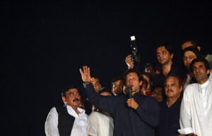 Pakistani opposition politician Imran Khan (C) addresses supporters after reaching the parliament during an anti-government march in Islamabad.