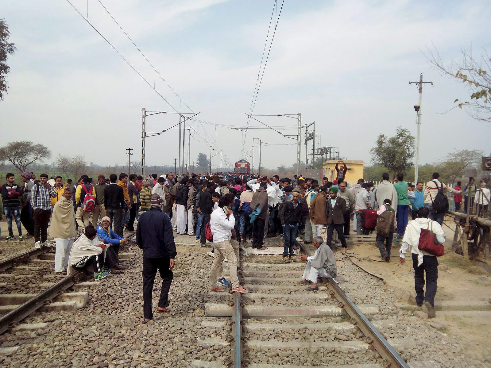 Jat community members block the railway tracks during their agitation for reservation near Rohtak. - PTI Photo